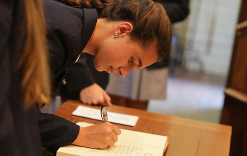 Student signing a book
