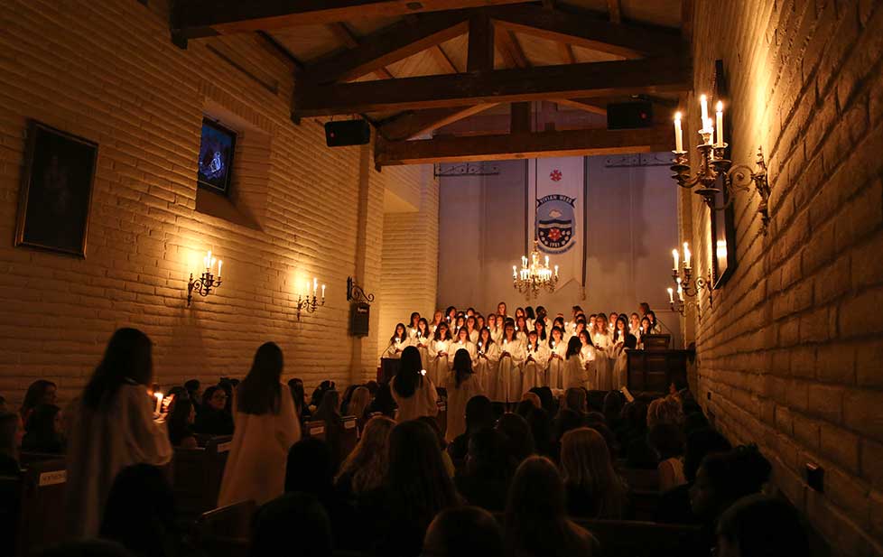 candlelight, students in a church ceremony